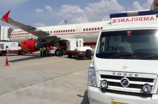 Arogyasewa medical evacuation team coordinating a patient transfer with an Air India flight at the airport.